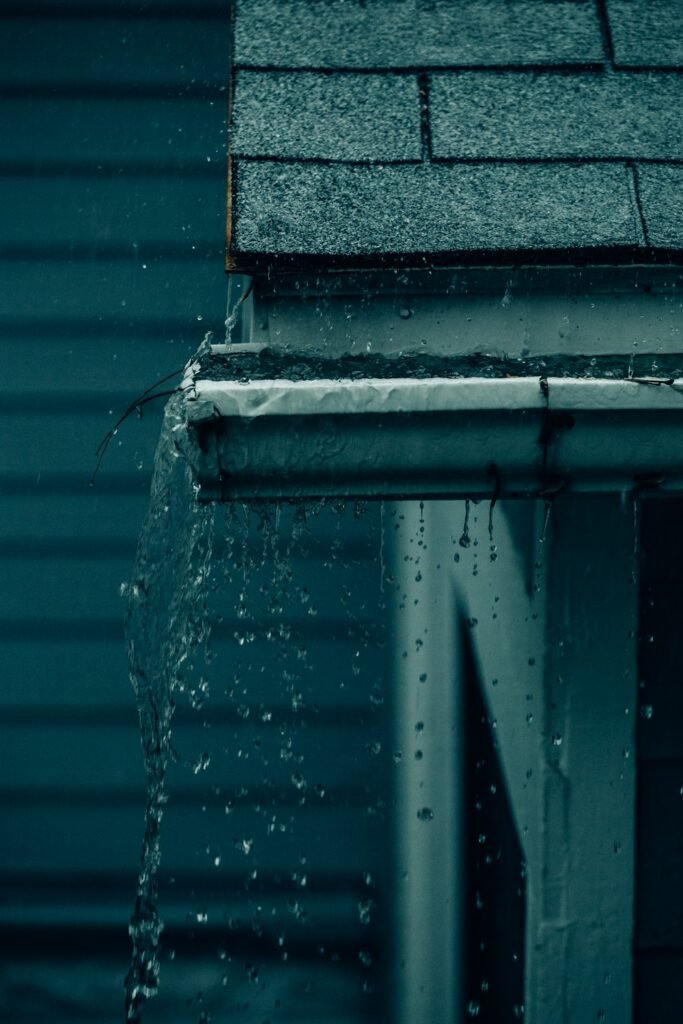 Water flowing off a roof edge during a clean