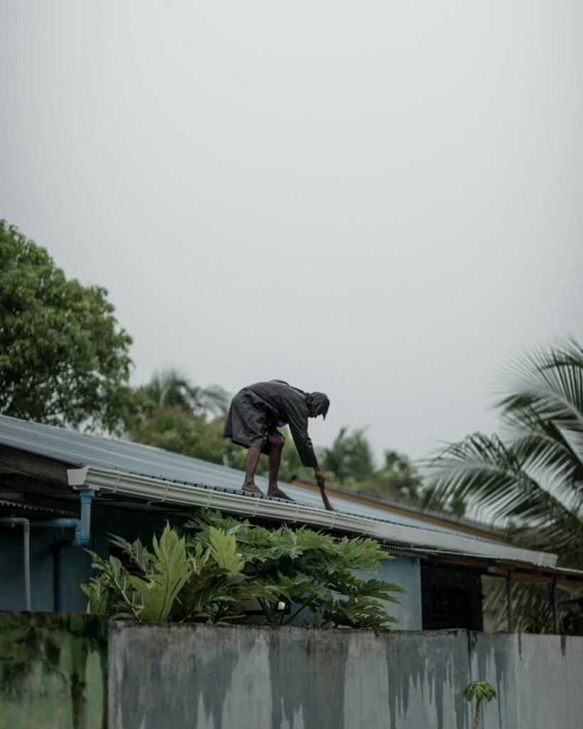 Person working on a pitched tiled roof